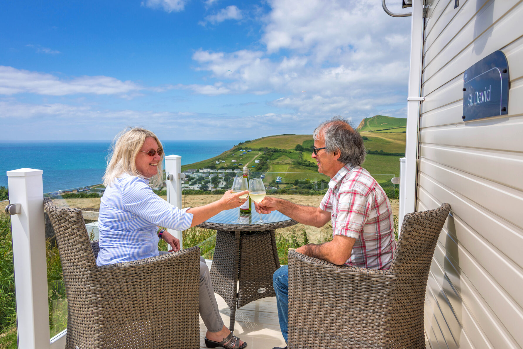 couple of enjoying a glass of wine on the veranda of self catering accommodation