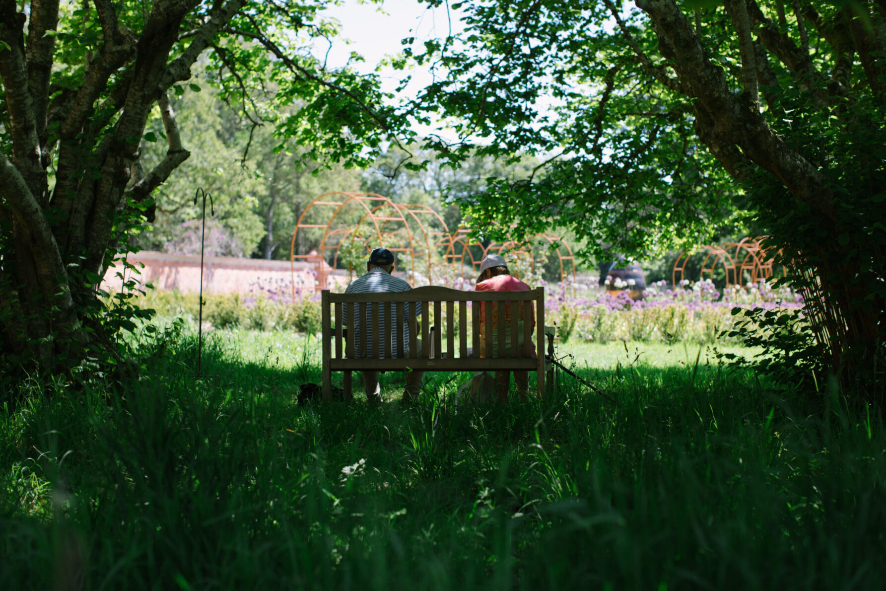 couple sat on a bench at carey's secret garden dorset