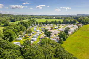 drone shot of caravan and tourer at scenic view of camping pitches at sandyholme holiday park in dorset south west england